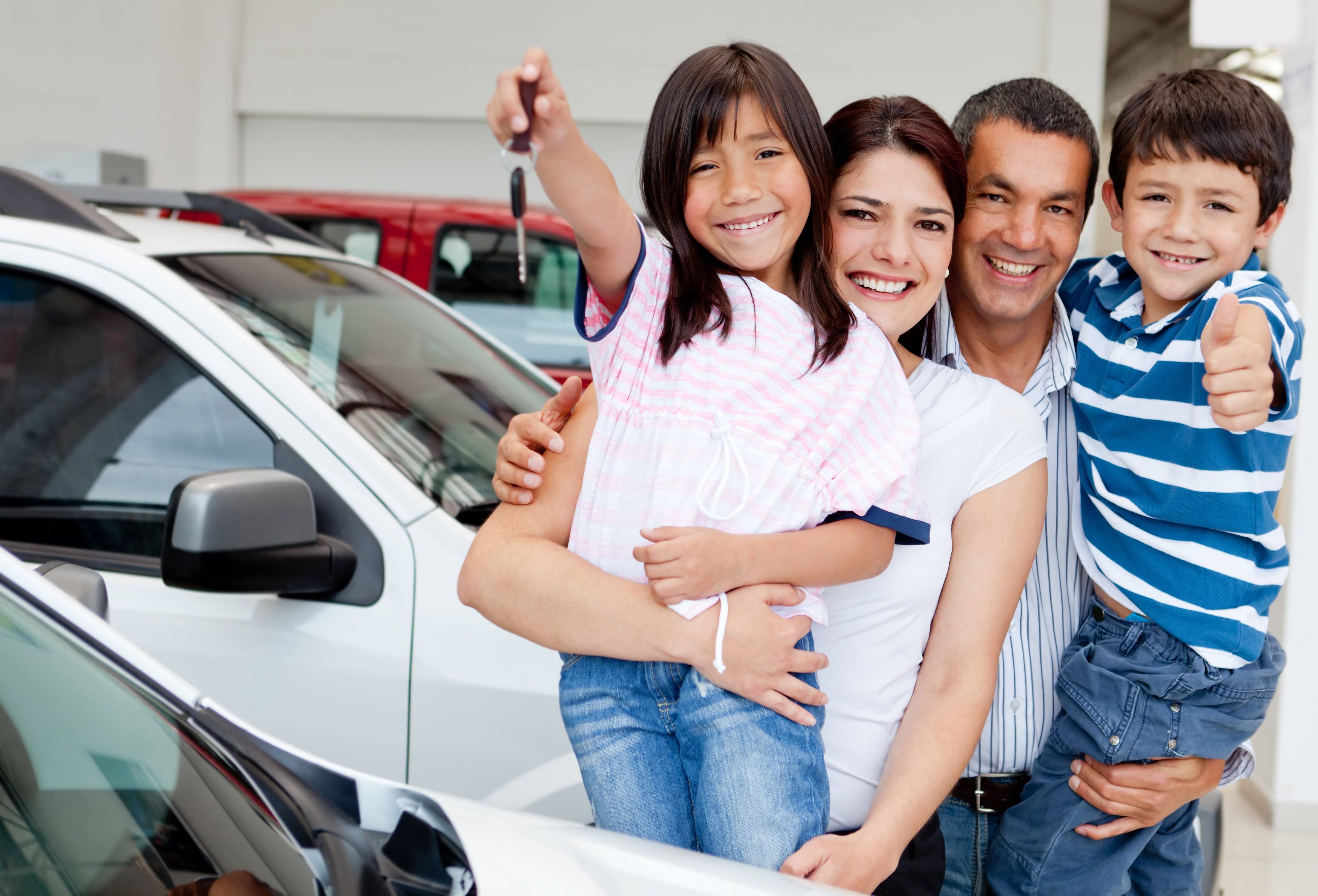 Happy family holding keys to new car Happy family holding keys to new car